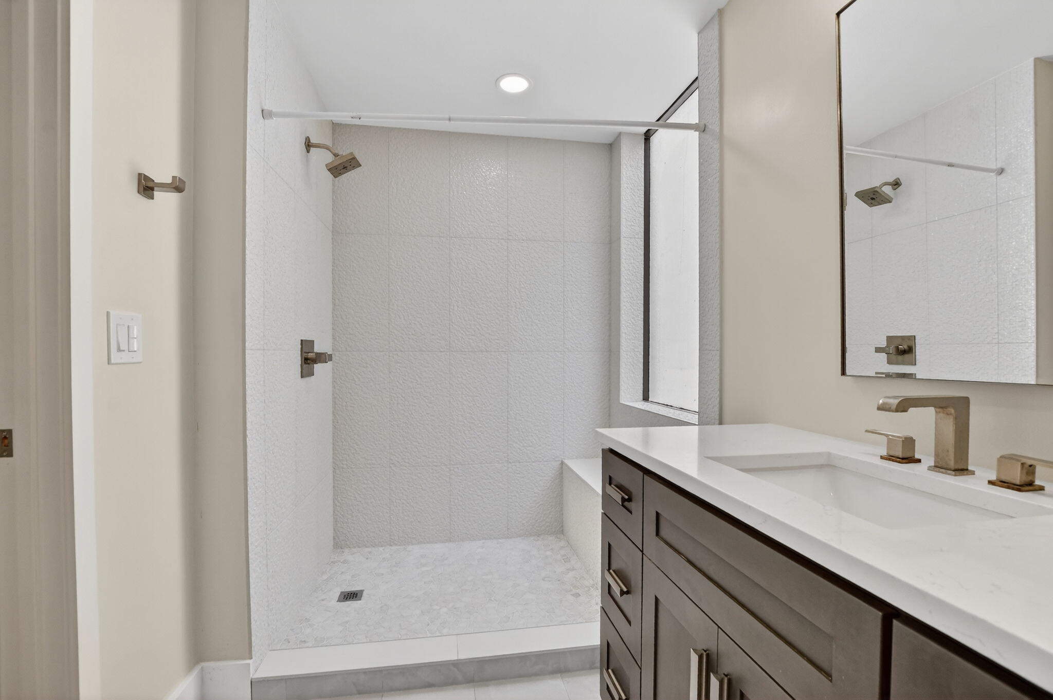 7472 La Paz Boulevard, Unit 304 Boca Raton, FL 33433 - Photo 22 of 36 a bathroom with a shower sink and mirror