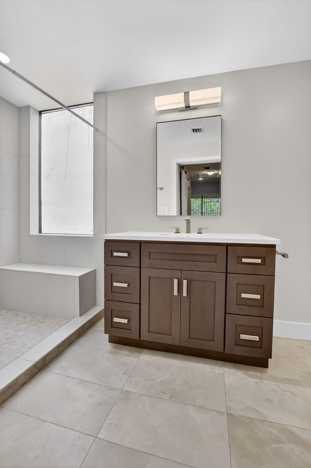 7472 La Paz Boulevard, Unit 304 Boca Raton, FL 33433 - Photo 24 of 36 a spacious bathroom with a tub sink and mirror
