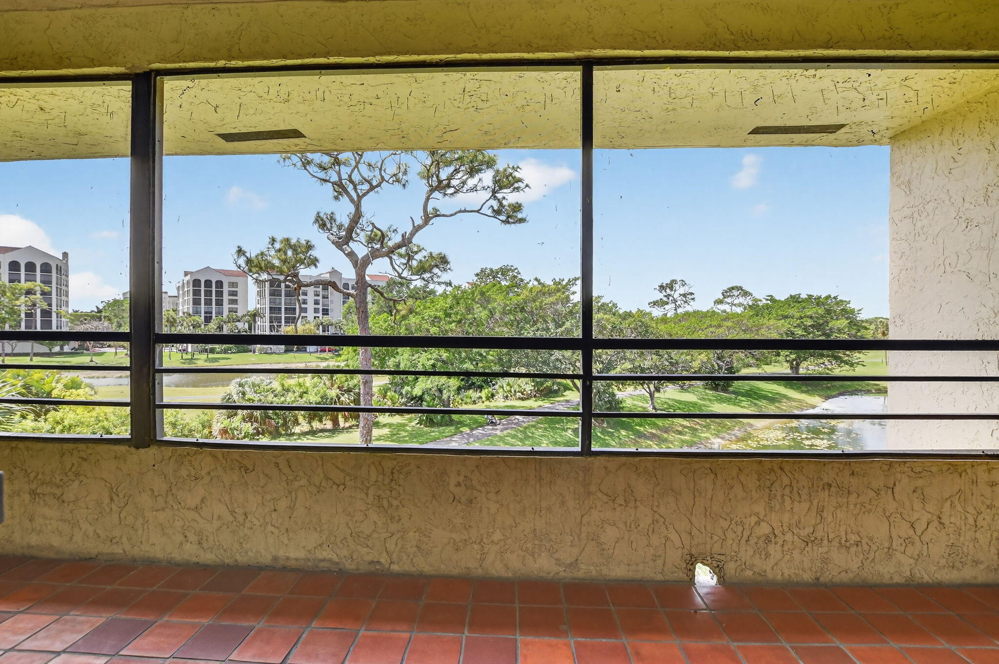 7472 La Paz Boulevard, Unit 304 Boca Raton, FL 33433 - Photo 25 of 36 a view of a lake from a balcony