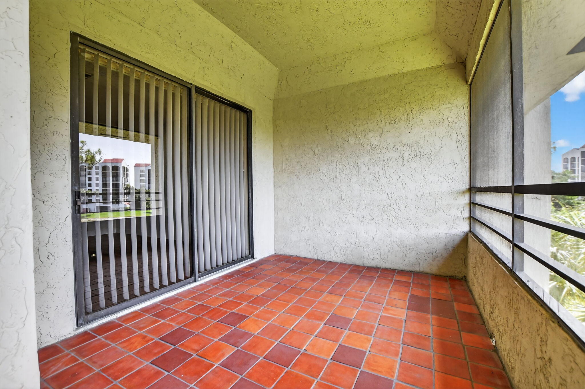 7472 La Paz Boulevard, Unit 304 Boca Raton, FL 33433 - Photo 26 of 36 a view of a balcony with wooden floor