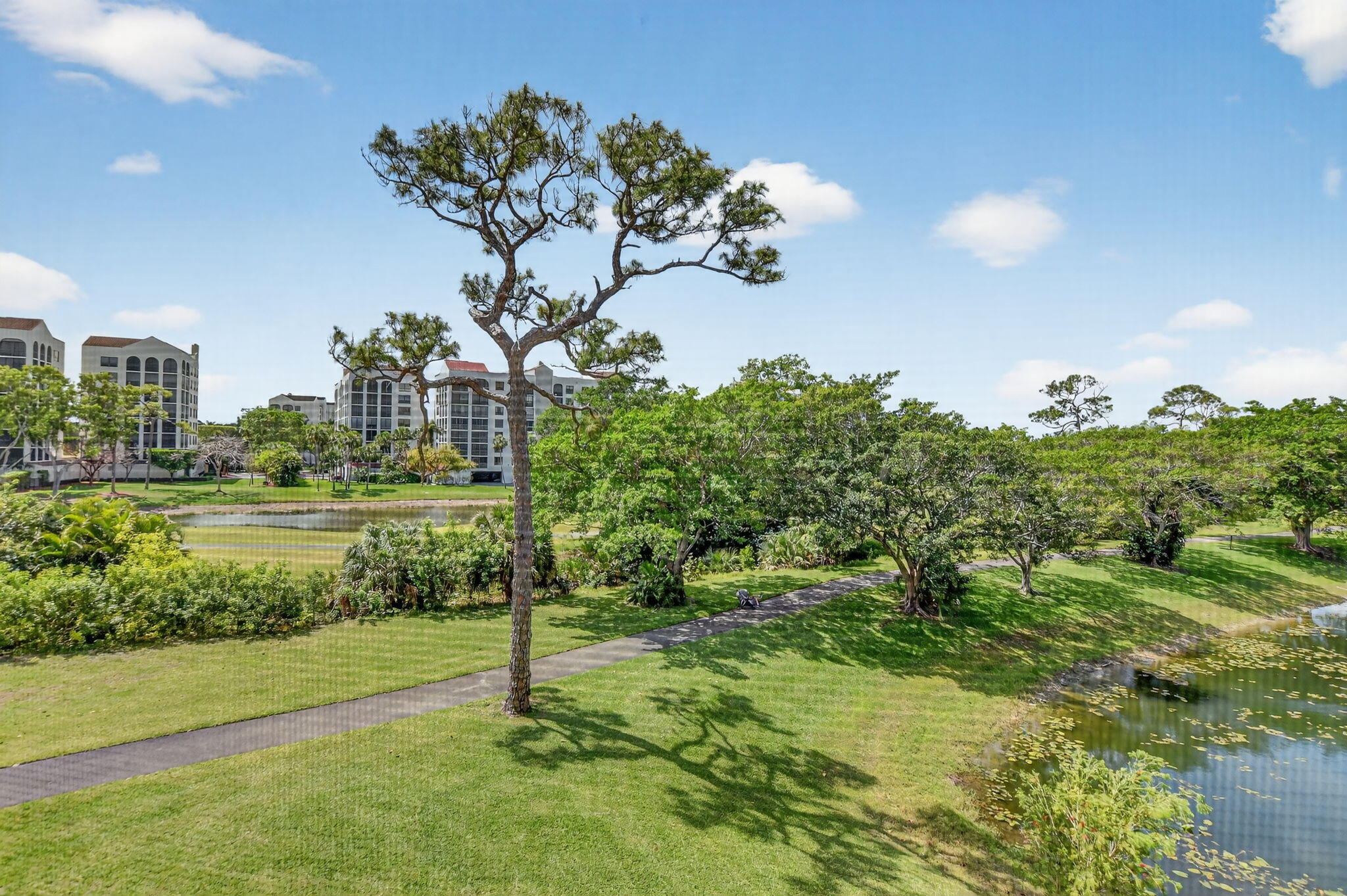 7472 La Paz Boulevard, Unit 304 Boca Raton, FL 33433 - Photo 30 of 36 a view of a garden with a lake