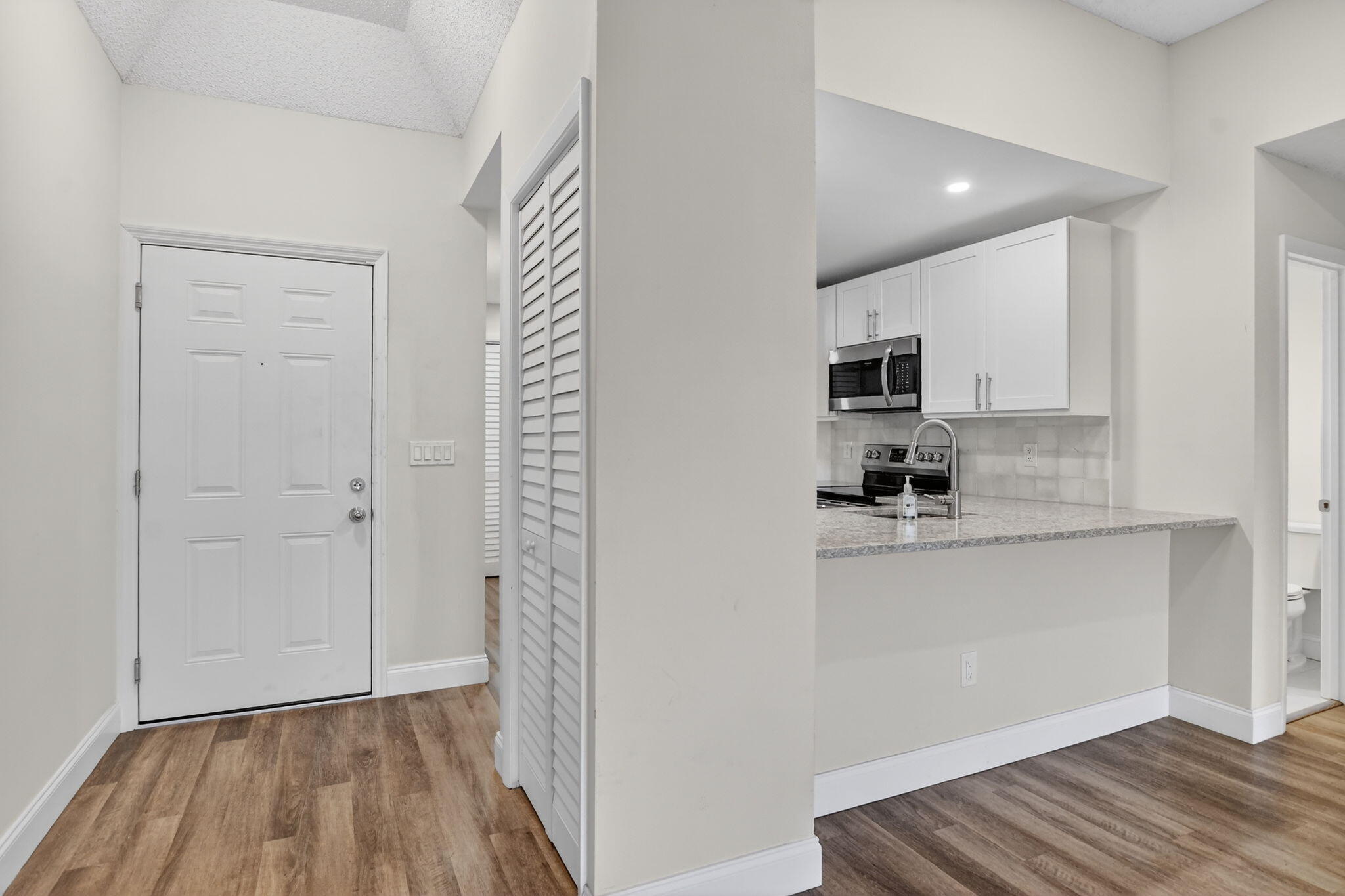 7472 La Paz Boulevard, Unit 304 Boca Raton, FL 33433 - Photo 3 of 36 a view of kitchen and wooden floor