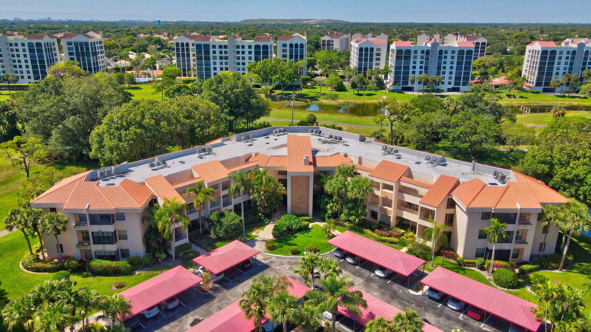 7472 La Paz Boulevard, Unit 304 Boca Raton, FL 33433 - Photo 31 of 36 an aerial view of multiple houses with yard