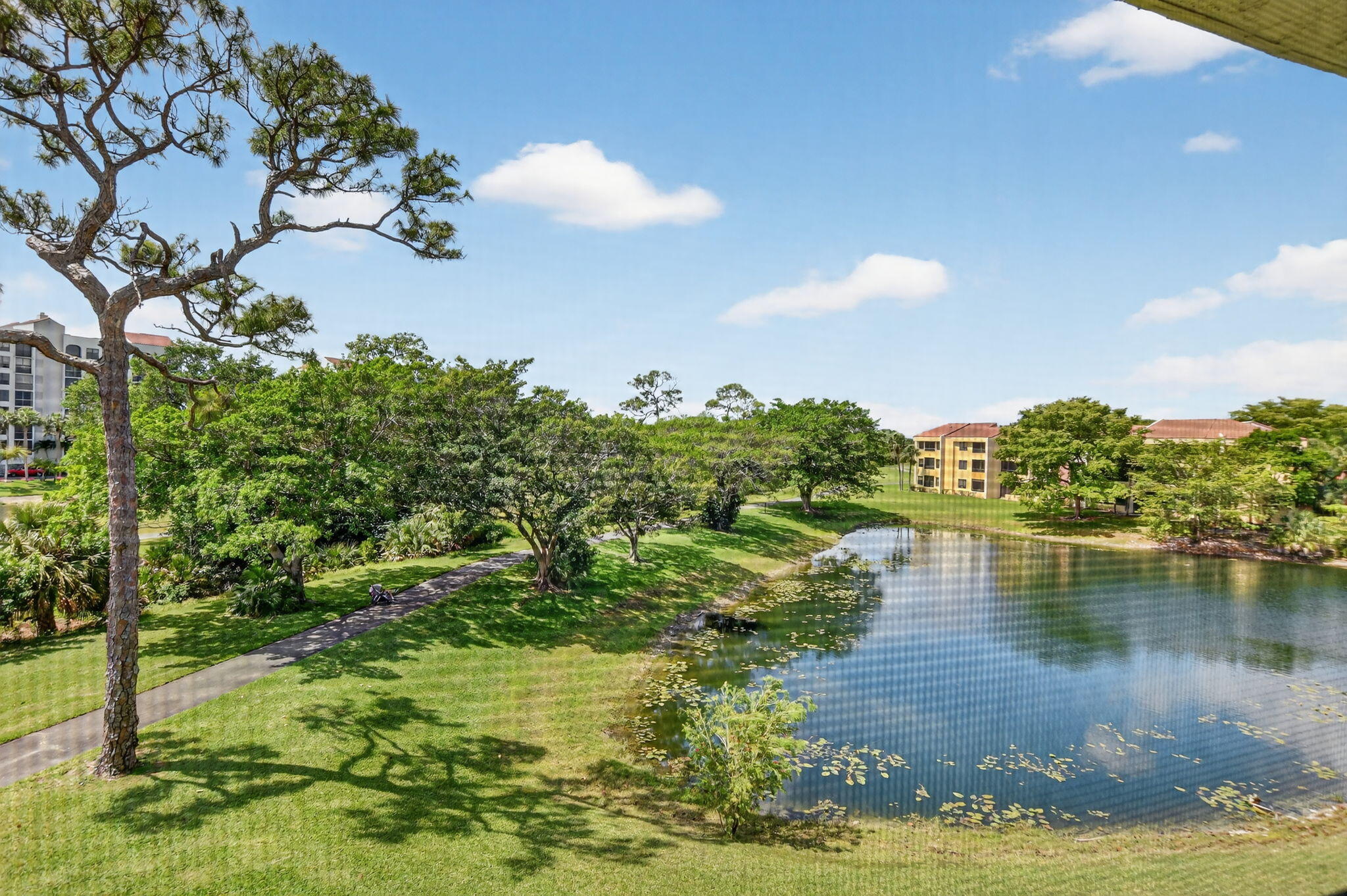 7472 La Paz Boulevard, Unit 304 Boca Raton, FL 33433 - Photo 4 of 36 a view of a lake with houses