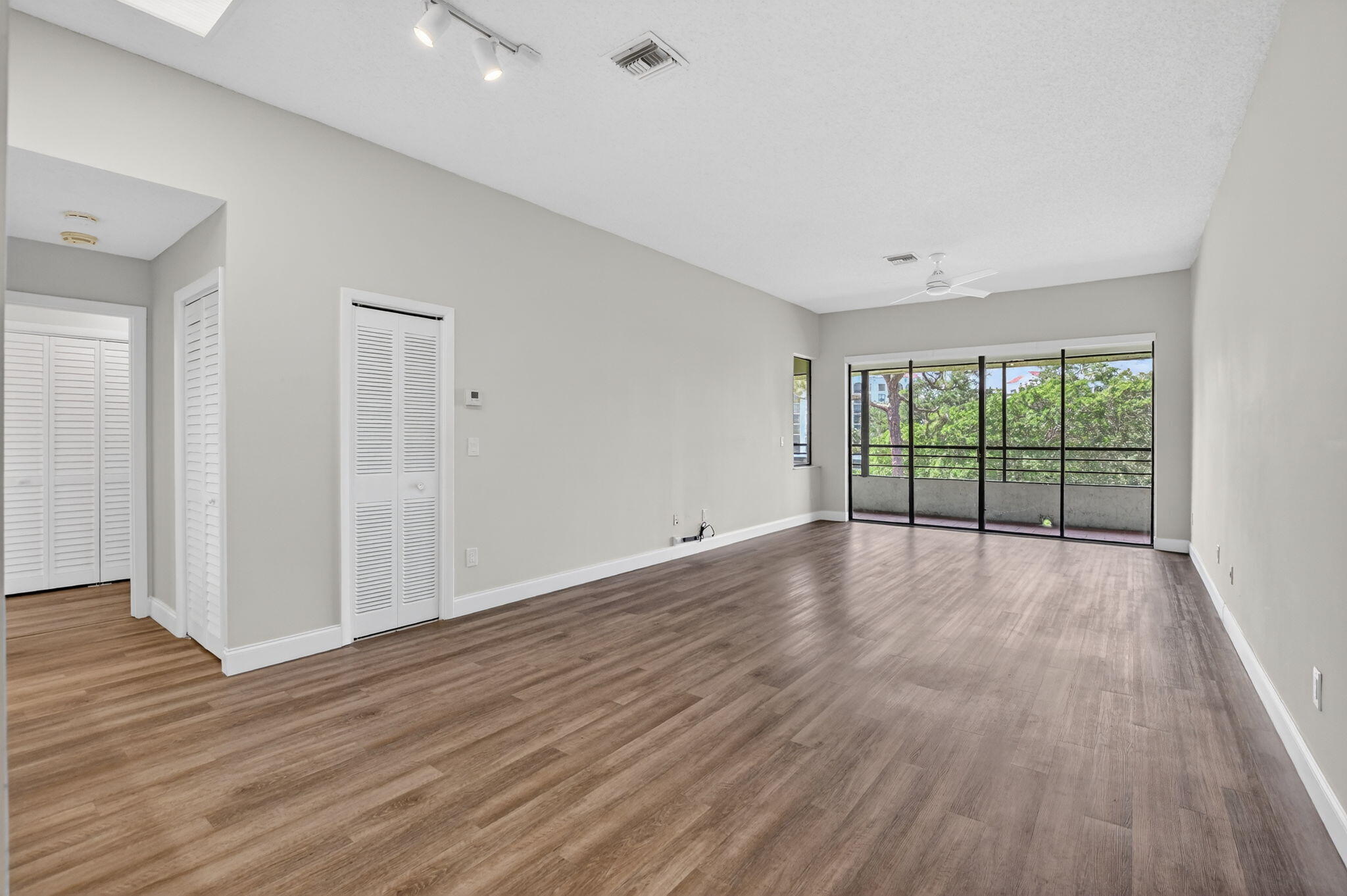 7472 La Paz Boulevard, Unit 304 Boca Raton, FL 33433 - Photo 5 of 36 a view of a room with wooden floor and window