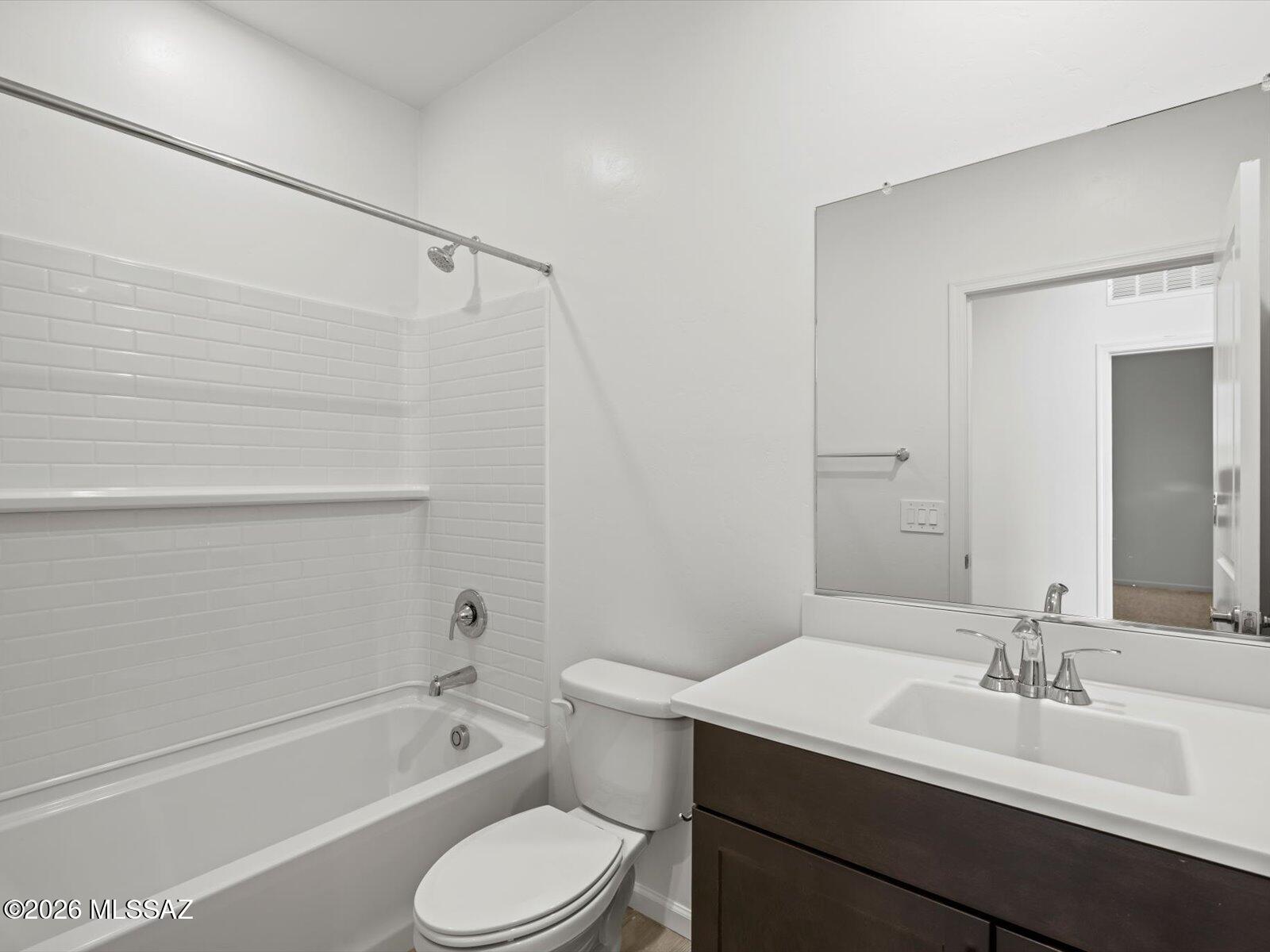 5133 West Gainer Ridge Road Tucson, AZ 85757 - Photo 1 of 16 a bathroom with a sink a toilet a mirror and shower