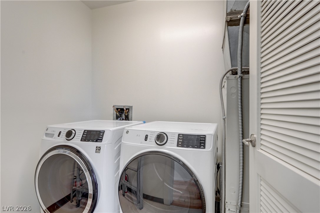 360 East Desert Inn Road, Unit 402 Las Vegas, NV 89109 - Photo 15 of 40 A well-appointed laundry area offers convenient access to modern washing and drying appliances.