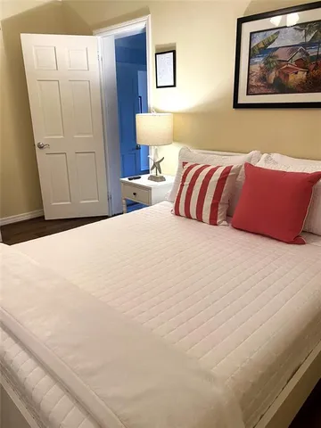 a bedroom with a bed and painting on the wall