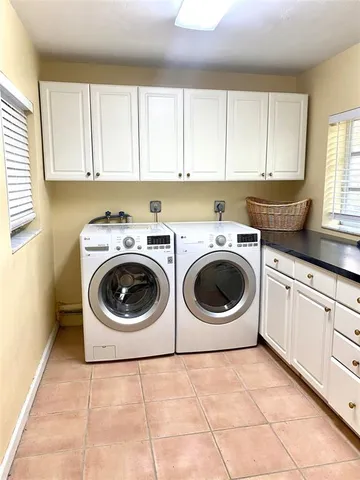 a utility room with sink washer and dryer