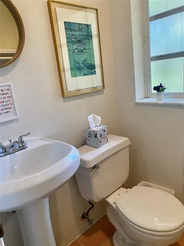 a bathroom with a sink mirror and toilet