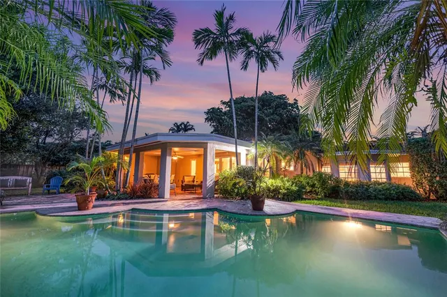 a swimming pool with outdoor seating and yard