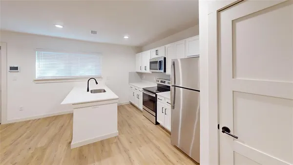 a view of a kitchen with electric appliances