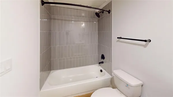 a bathroom with a toilet and a bathtub