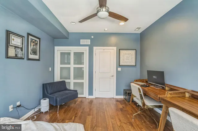 a bedroom with a bed and a desk