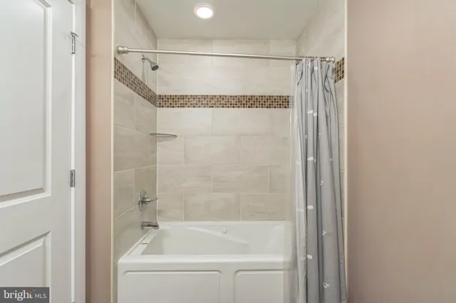 a bathroom with a shower and a bath tub