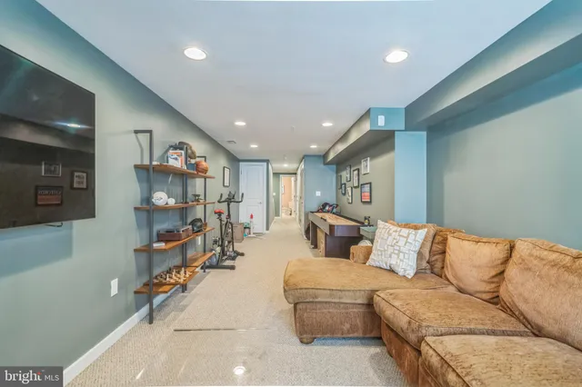 a living room with furniture and view of kitchen