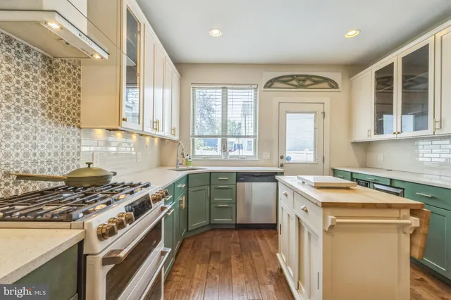 a kitchen with a stove a sink and a granite counter tops