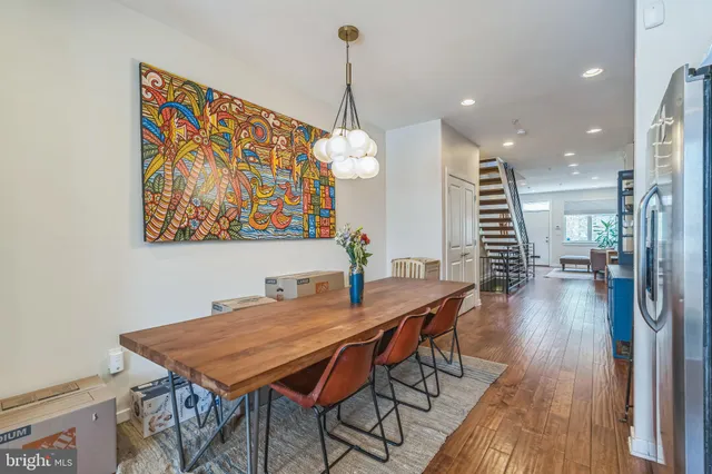 a dining room with furniture and wooden floor