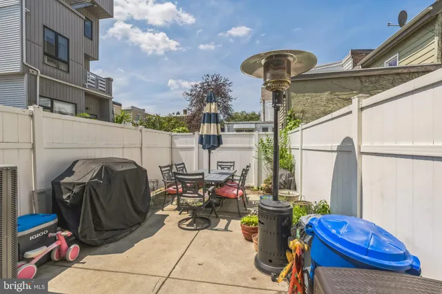 a view of balcony with chairs and potted plants