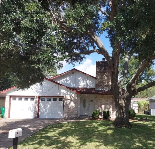 a view of house with yard in front of it