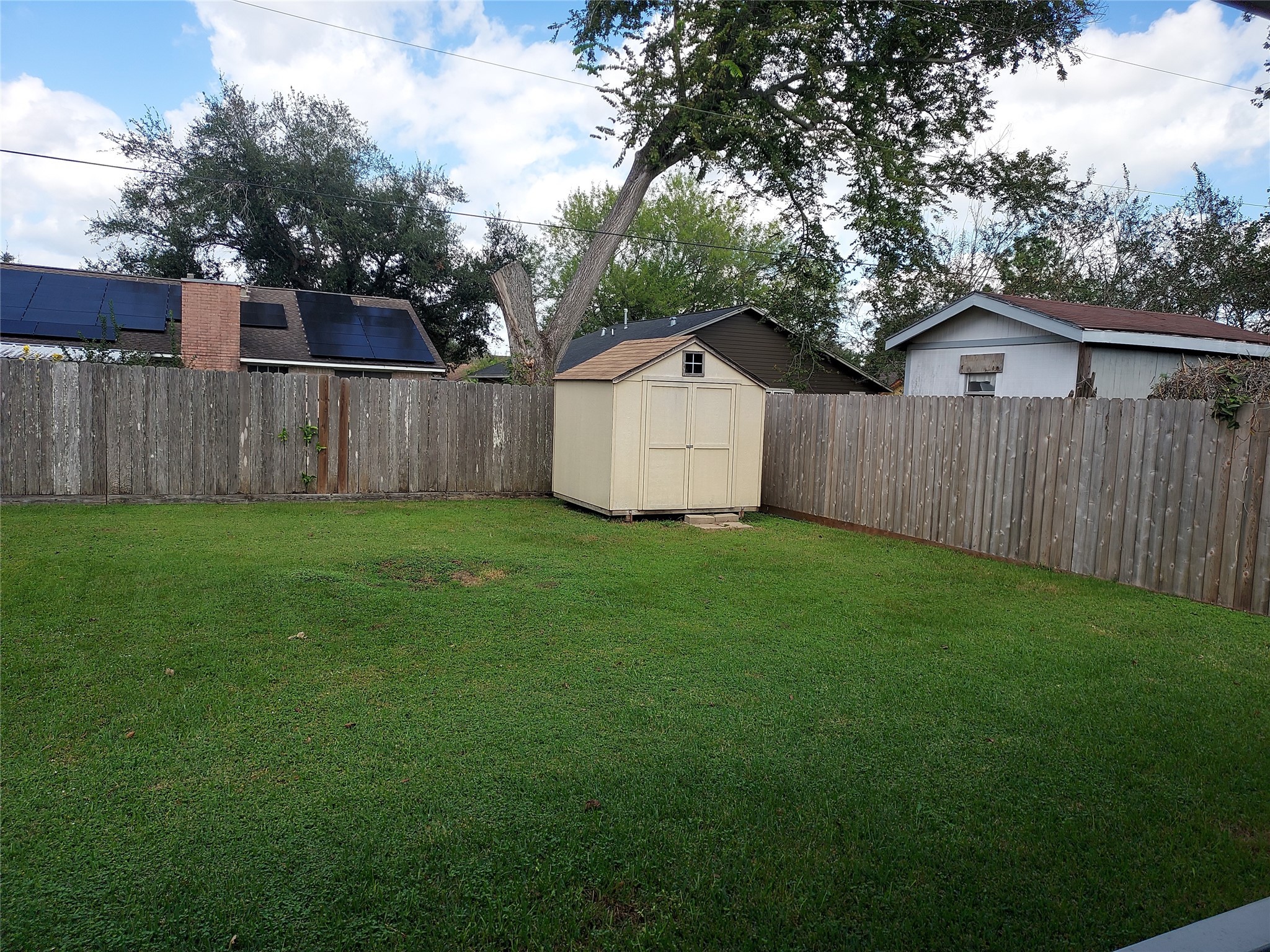 1305 Sagebrush Street Angleton, TX 77515 - Photo 11 of 12 a view of a yard with a house and a large tree