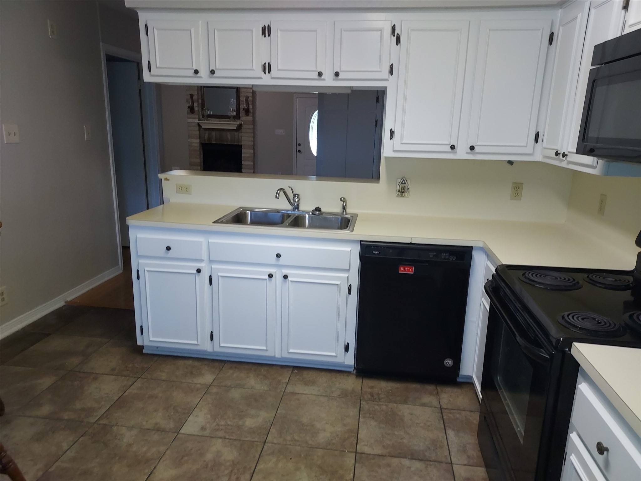 1305 Sagebrush Street Angleton, TX 77515 - Photo 4 of 12 a kitchen with stainless steel appliances granite countertop a sink and a stove
