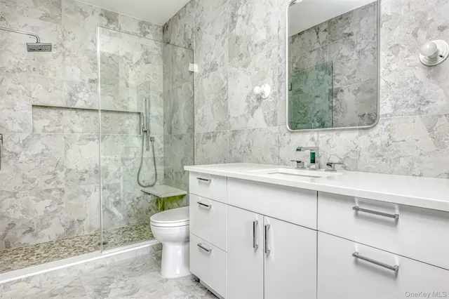 a bathroom with a sink toilet and shower