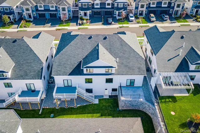 an aerial view of a house with swimming pool outdoor seating and yard