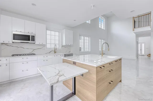 a kitchen with a stove a sink and a microwave