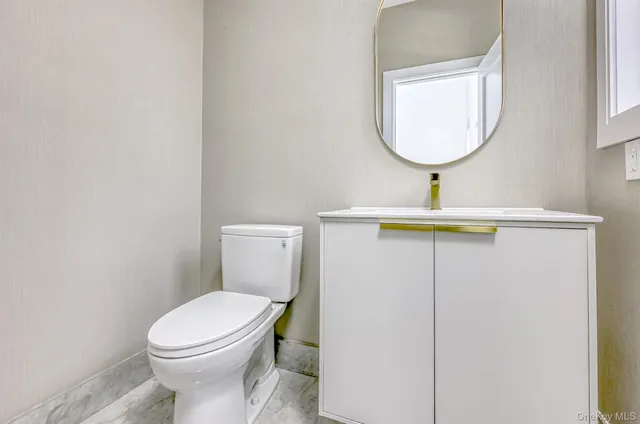 a bathroom with a toilet and a sink