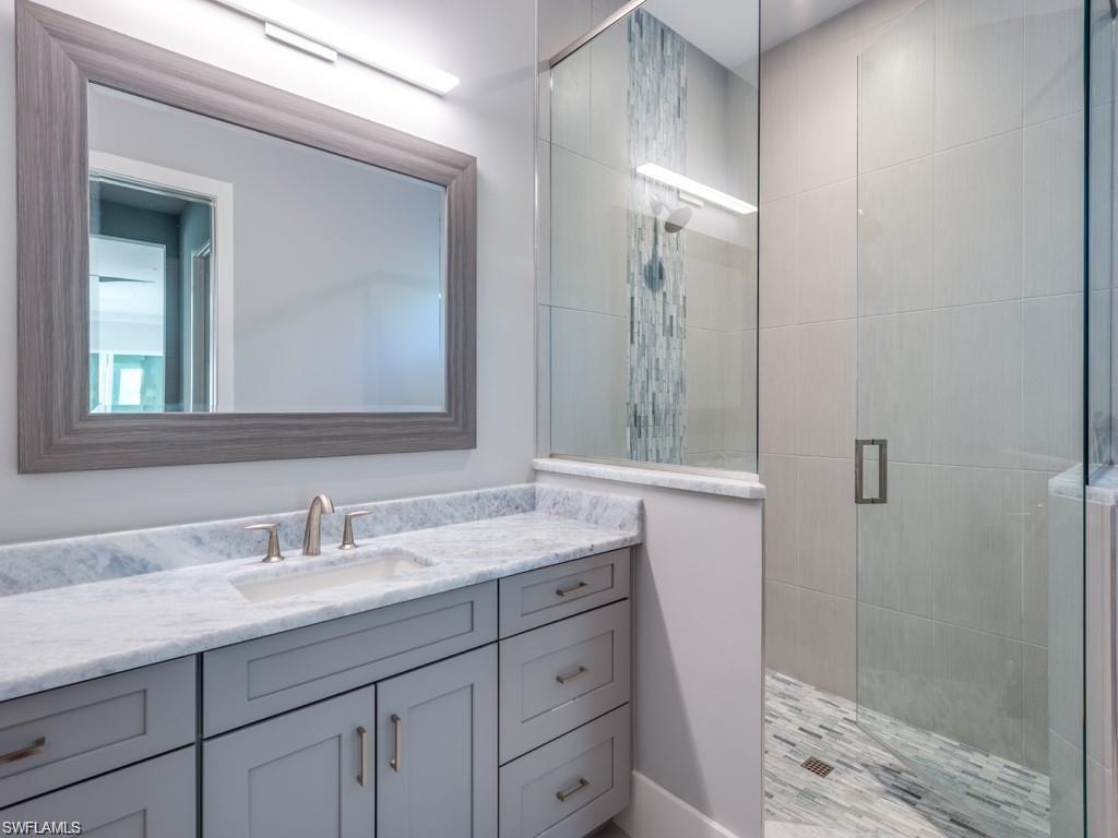 16892 Brightling Way Naples, FL 34110 - Photo 11 of 33 a bathroom with a sink and a mirror