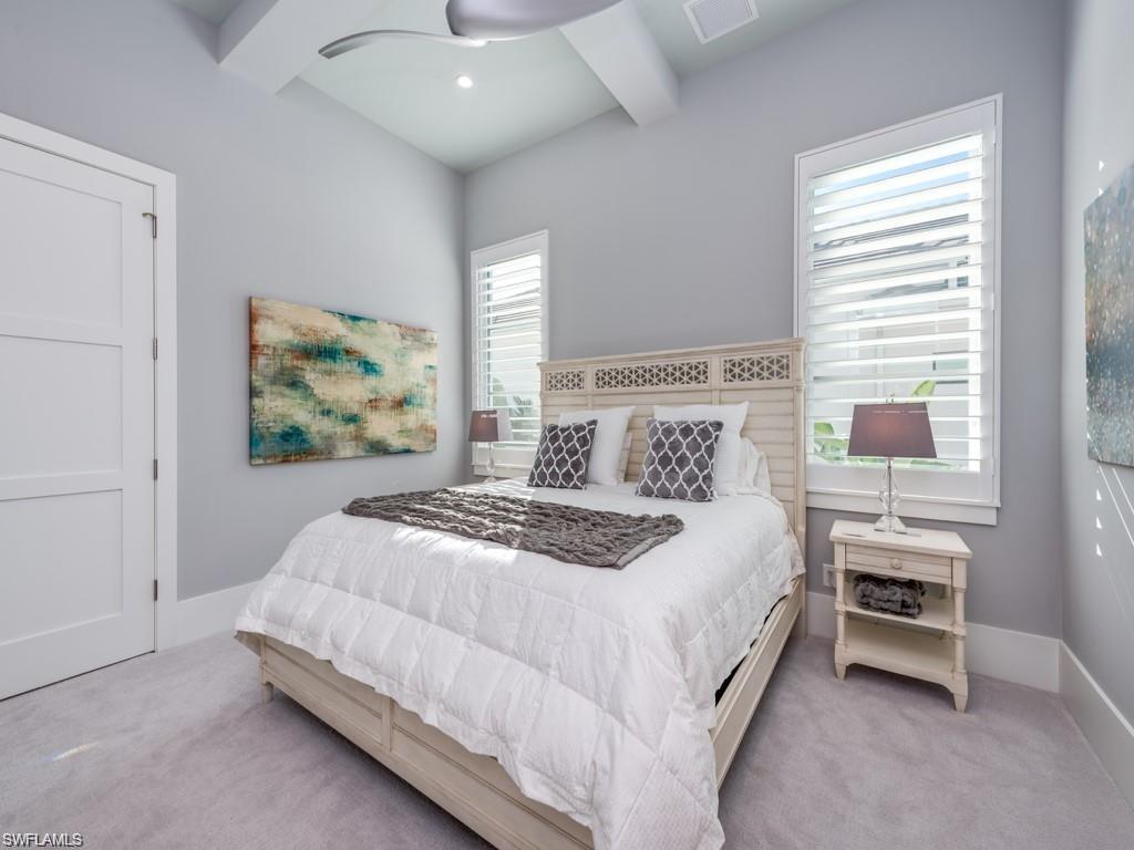 16892 Brightling Way Naples, FL 34110 - Photo 12 of 33 a bedroom with a bed and a painting on the wall