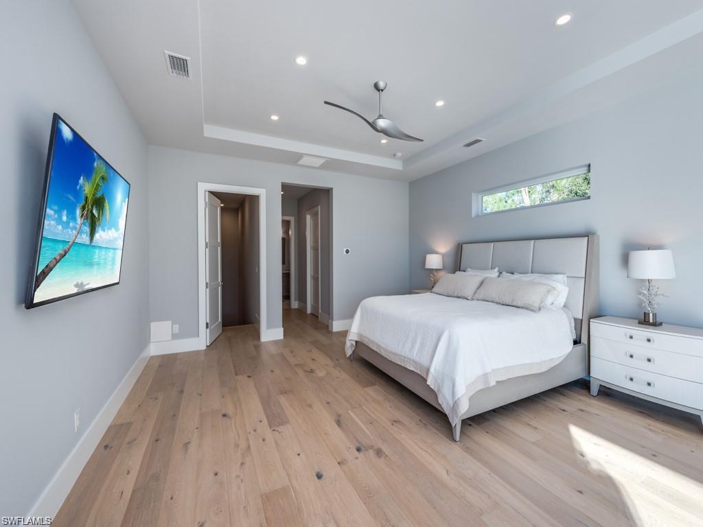 16892 Brightling Way Naples, FL 34110 - Photo 14 of 33 a bedroom with a bed and a painting on the wall
