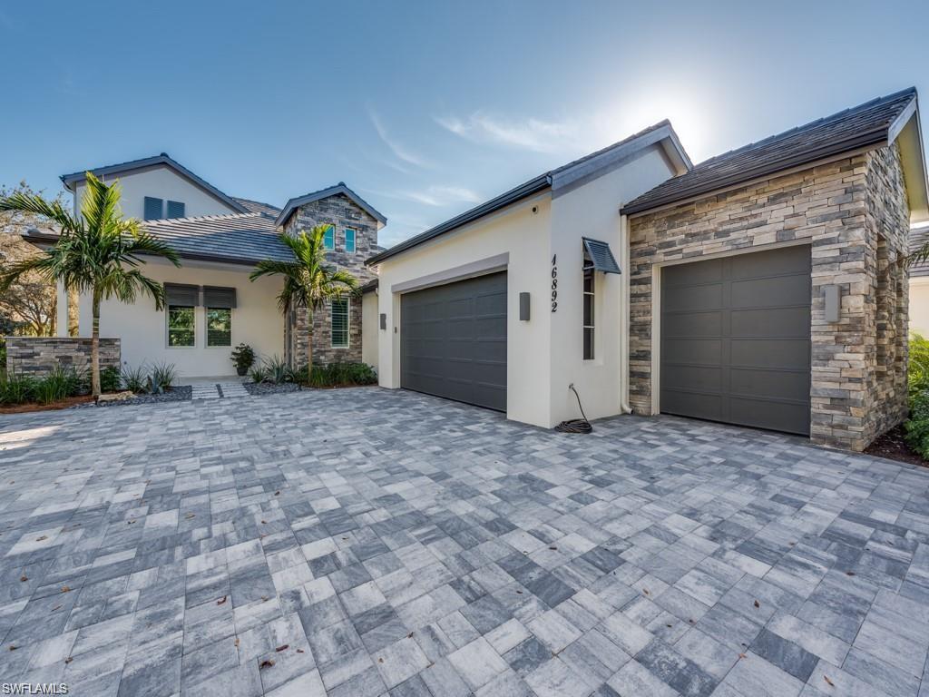 16892 Brightling Way Naples, FL 34110 - Photo 23 of 33 a view of a house with a yard and garage