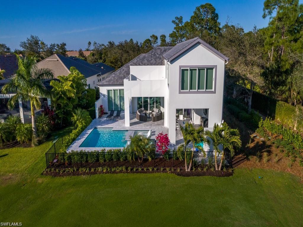 16892 Brightling Way Naples, FL 34110 - Photo 24 of 33 a front view of a house with a garden and yard