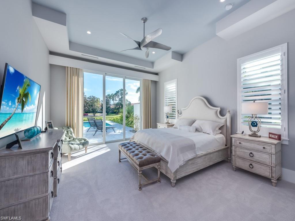 16892 Brightling Way Naples, FL 34110 - Photo 8 of 33 a bedroom with a bed and large flat screen tv