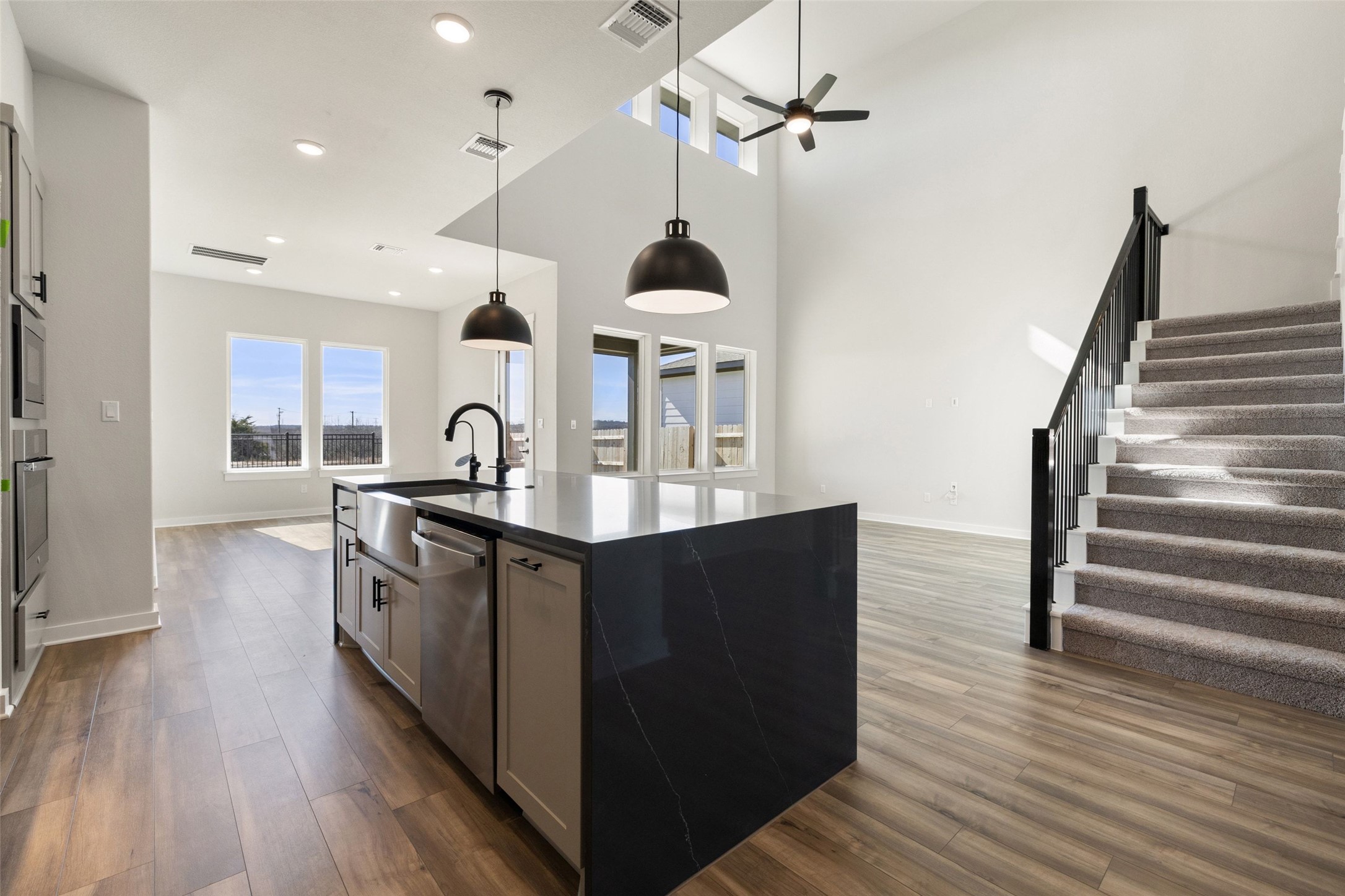 16309 Smithers Road Manor, TX 78653 - Photo 12 of 40 a kitchen with stainless steel appliances granite countertop a sink and wooden floor