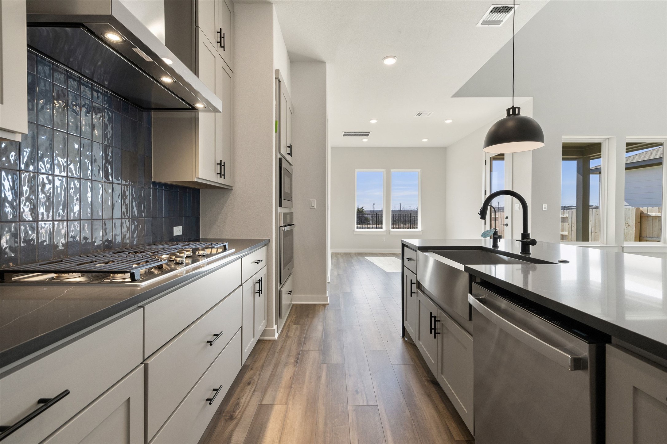 16309 Smithers Road Manor, TX 78653 - Photo 13 of 40 a kitchen with sink stove and cabinets
