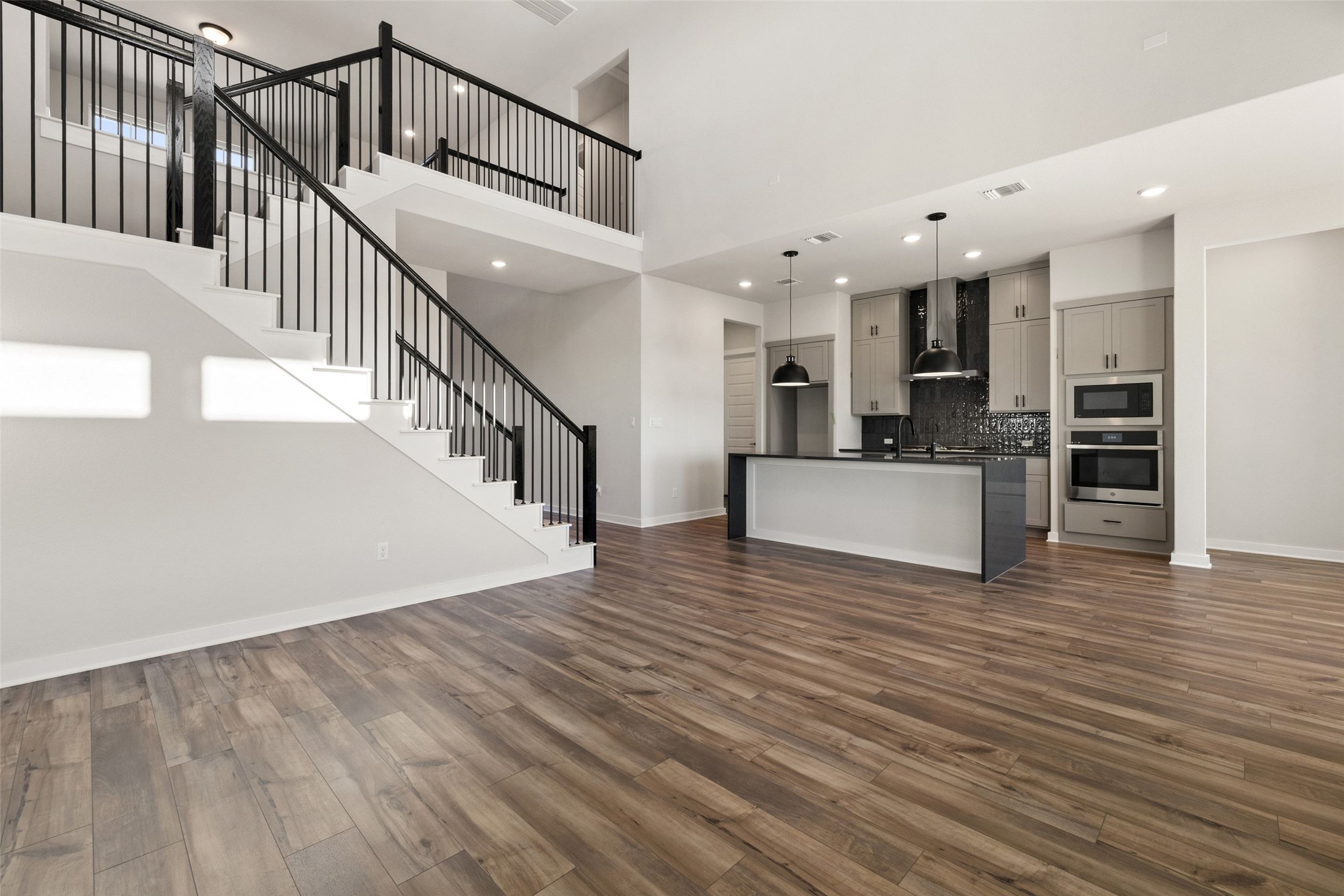16309 Smithers Road Manor, TX 78653 - Photo 18 of 40 a view of staircase and kitchen with sink