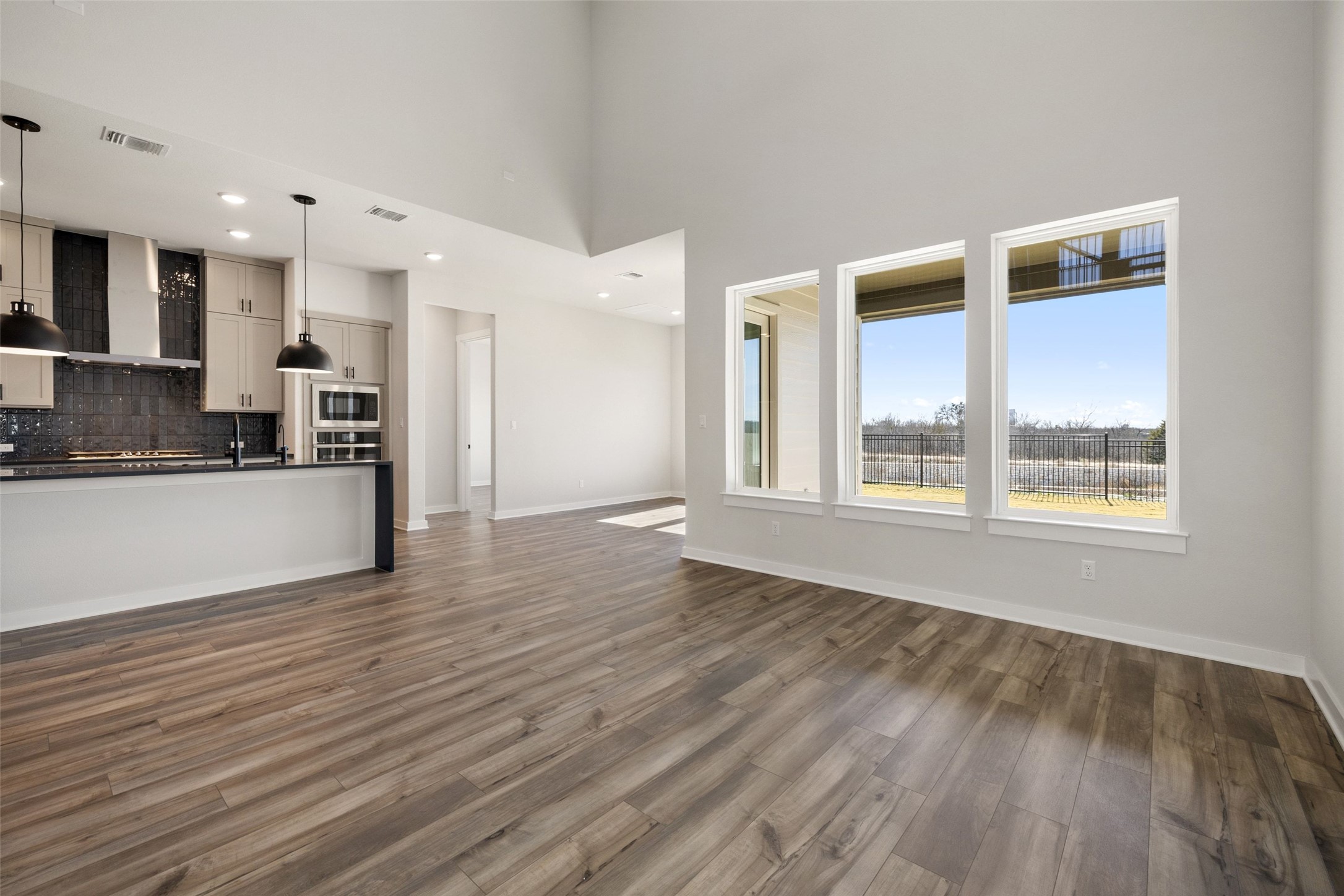16309 Smithers Road Manor, TX 78653 - Photo 19 of 40 a view of a kitchen with a sink and dishwasher kitchen view with wooden floor