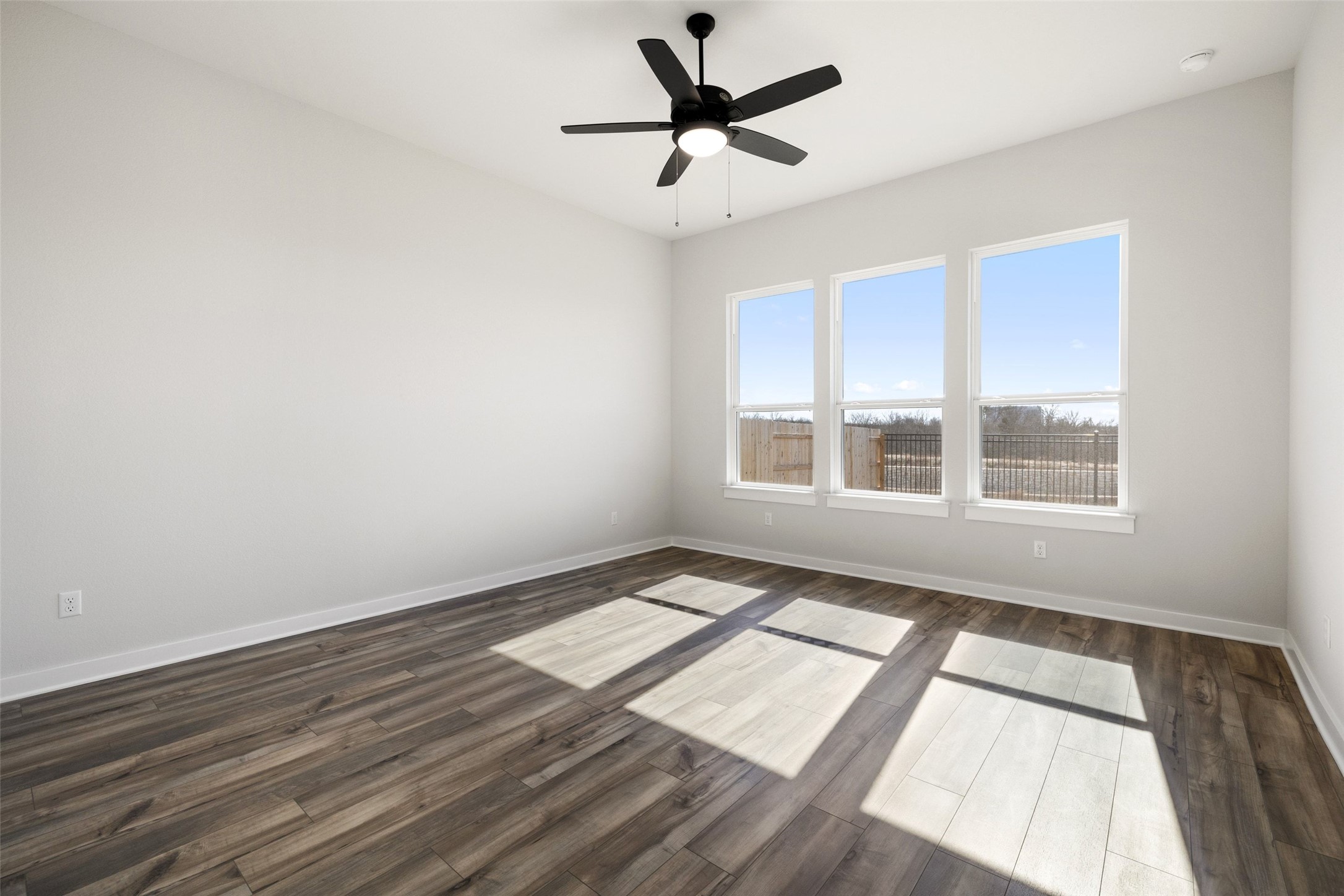 16309 Smithers Road Manor, TX 78653 - Photo 20 of 40 a view of an empty room with a window and wooden floor