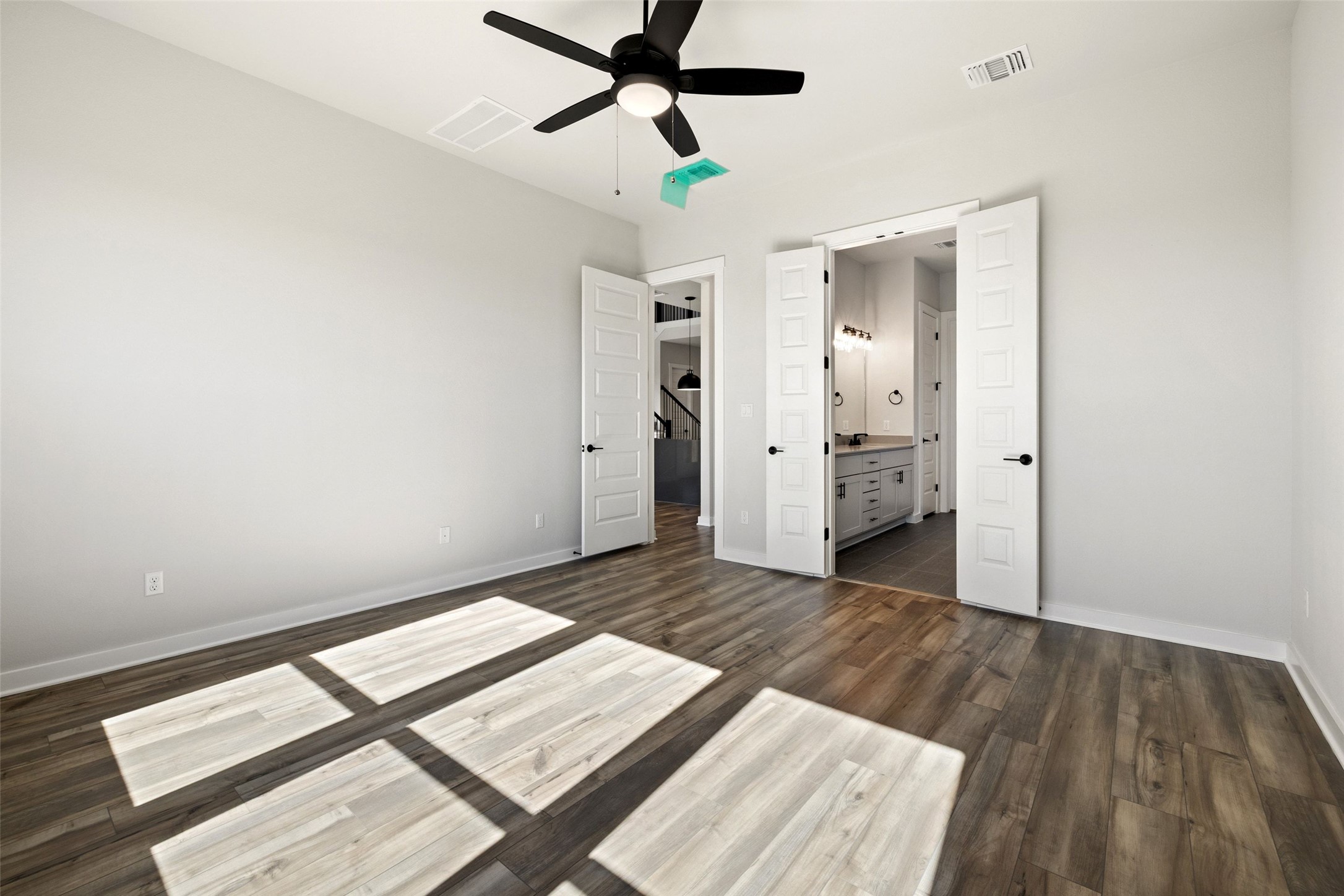 16309 Smithers Road Manor, TX 78653 - Photo 21 of 40 a view of hallway with wooden floor and a ceiling fan