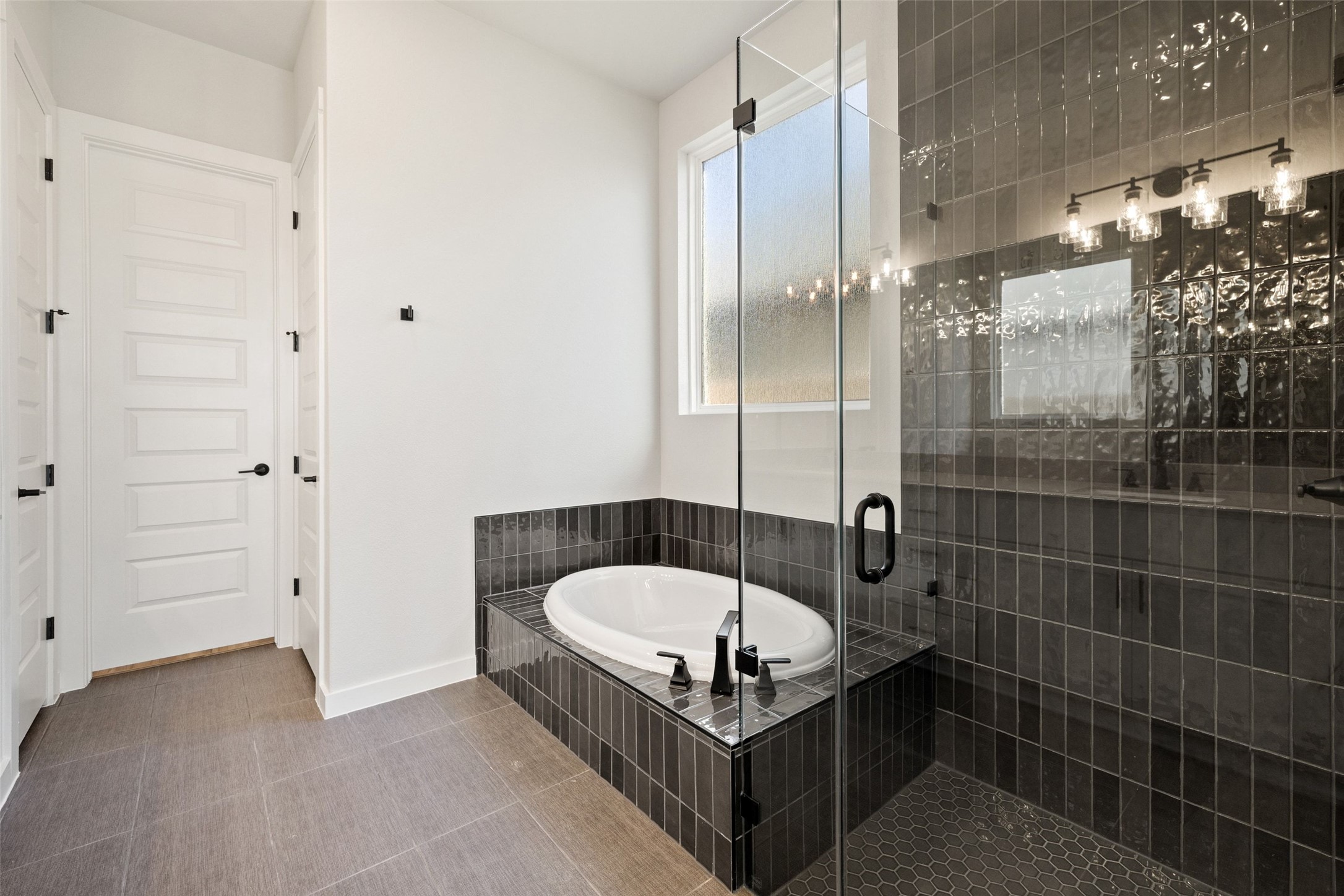 16309 Smithers Road Manor, TX 78653 - Photo 24 of 40 a bathroom with a tub and shower