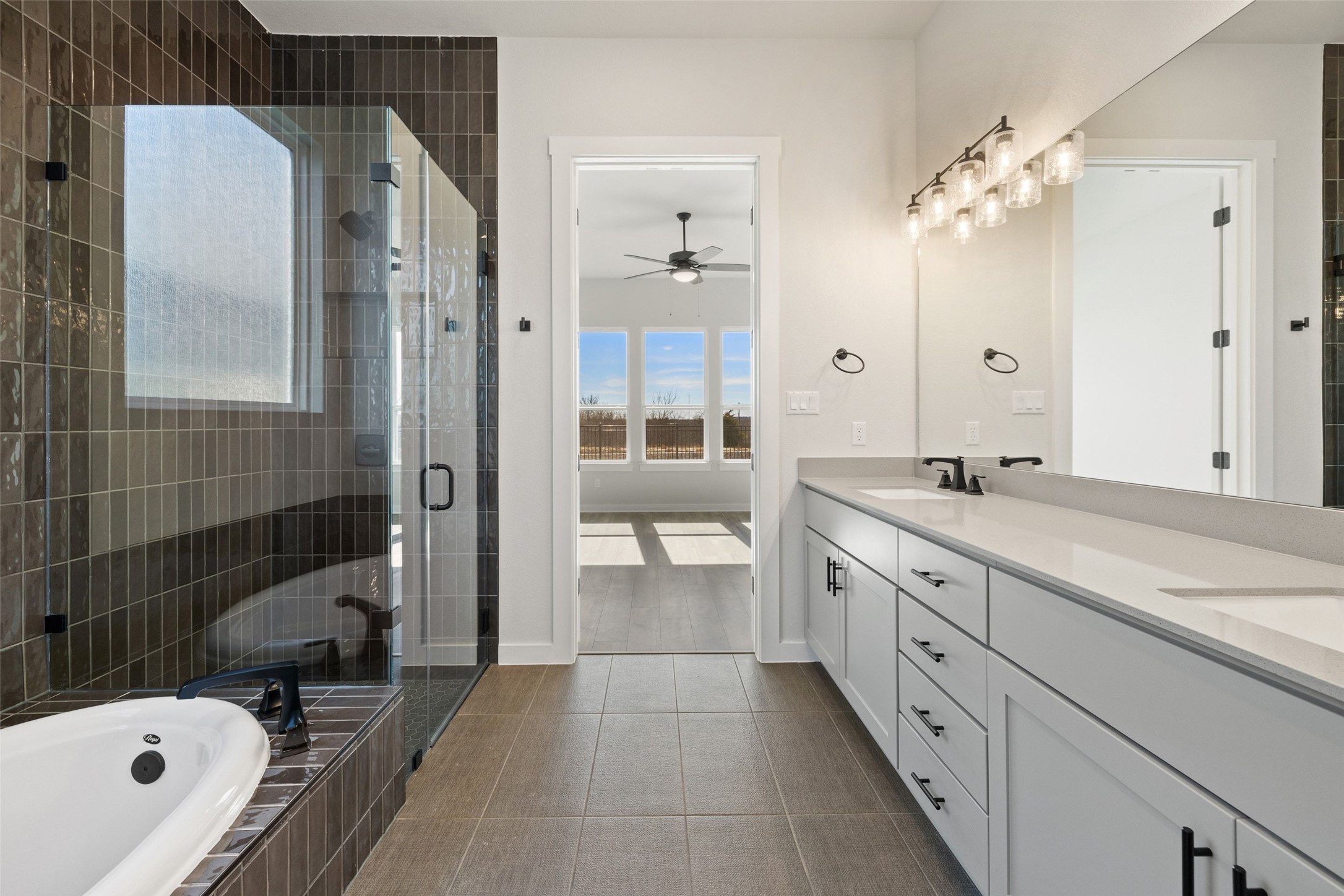 16309 Smithers Road Manor, TX 78653 - Photo 25 of 40 a spacious bathroom with a granite countertop tub sink and mirror