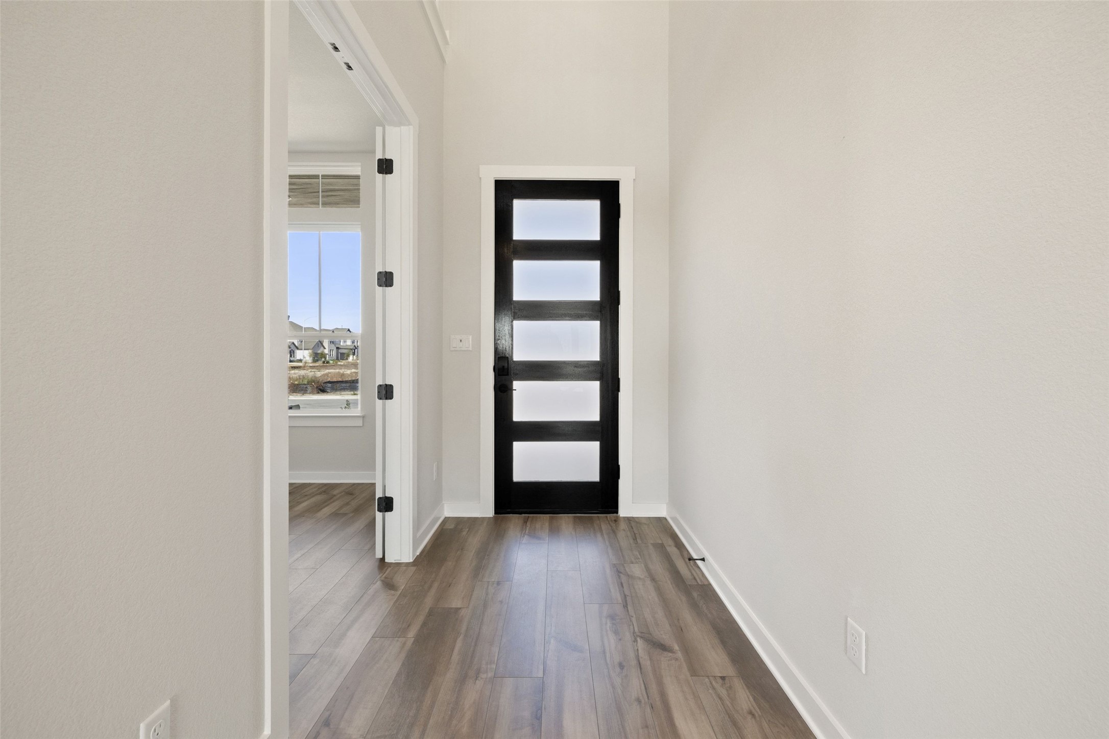 16309 Smithers Road Manor, TX 78653 - Photo 3 of 40 a view of a hallway with wooden floor and closet