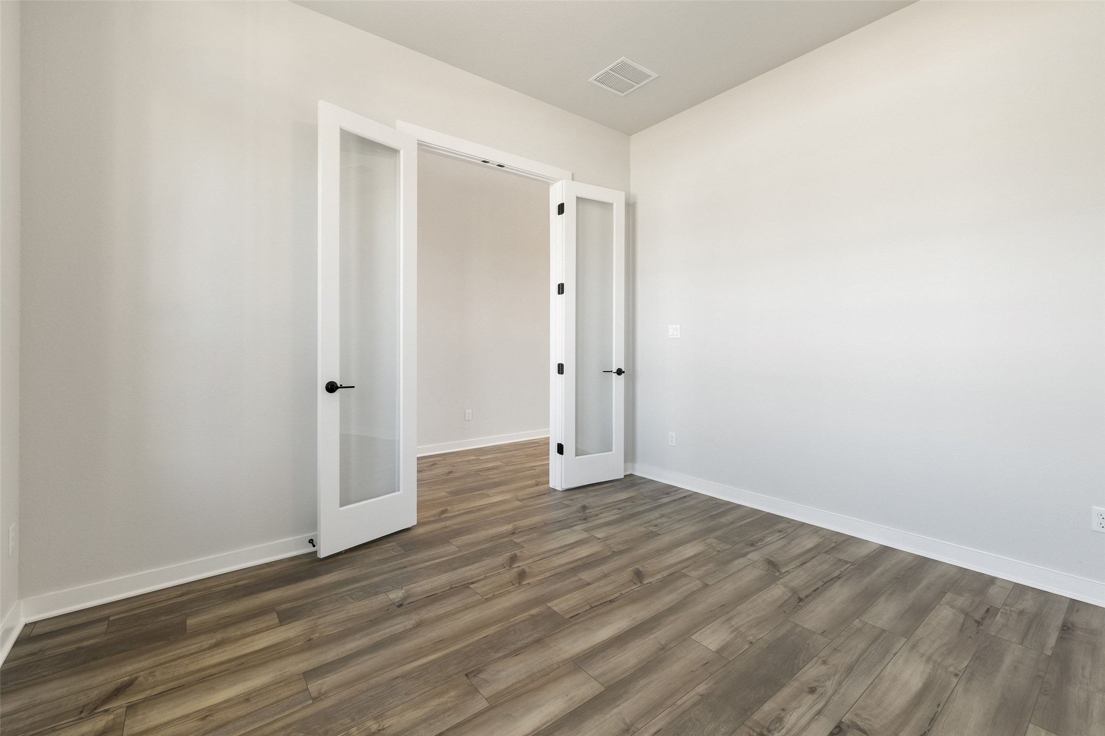 16309 Smithers Road Manor, TX 78653 - Photo 5 of 40 a view of an empty room with wooden floor