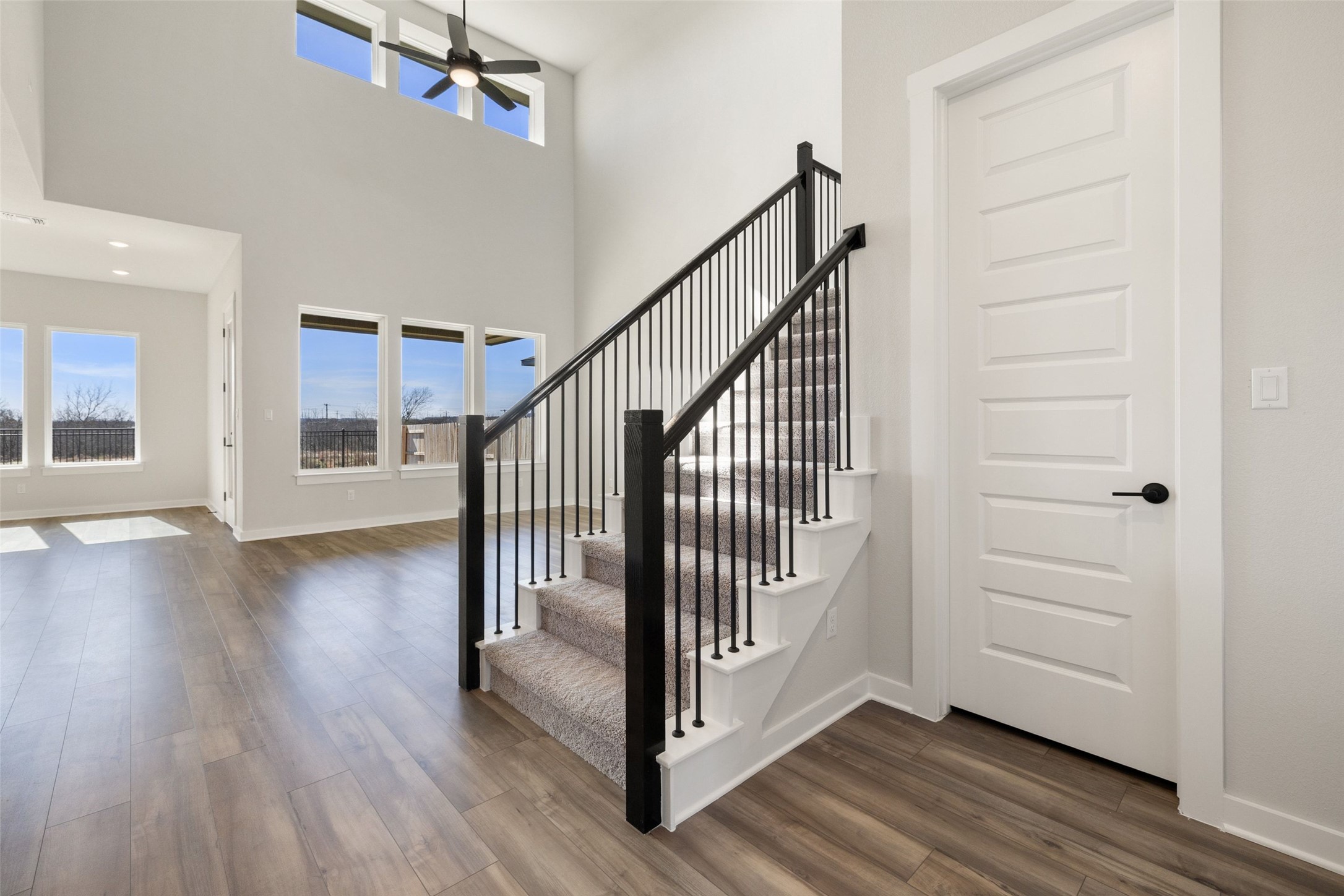 16309 Smithers Road Manor, TX 78653 - Photo 8 of 40 a view of a hallway with wooden floor and staircase