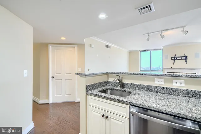 a kitchen with a sink and cabinets