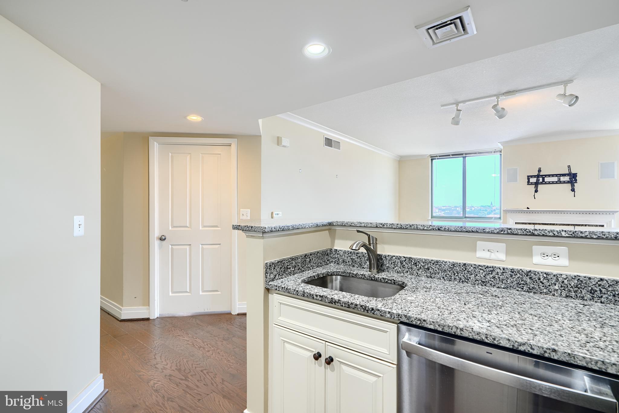 414 Water Street, Unit 1513 Baltimore, MD 21202 - Photo 12 of 43 a kitchen with a sink and cabinets