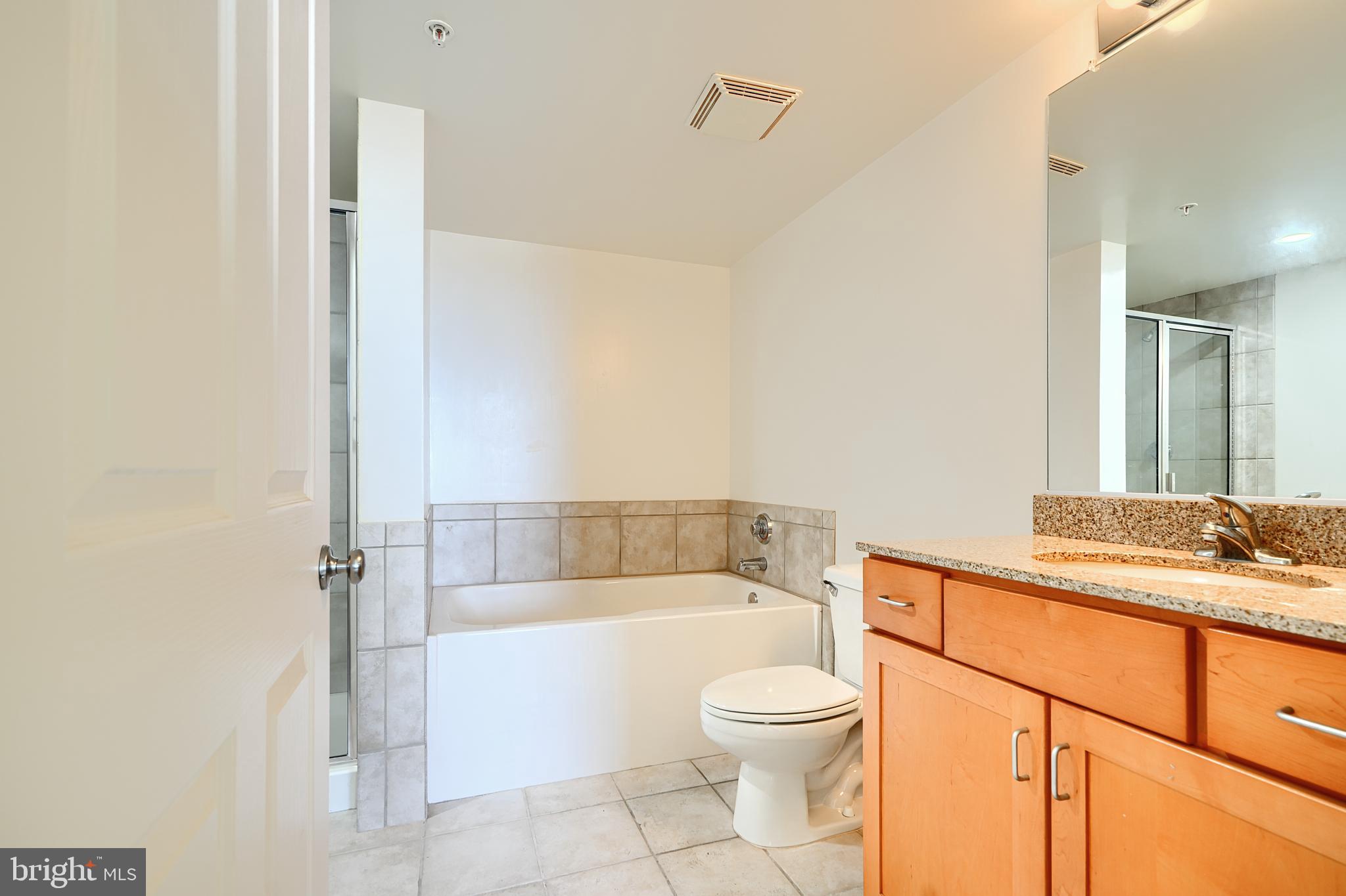 414 Water Street, Unit 1513 Baltimore, MD 21202 - Photo 23 of 43 a bathroom with a sink a toilet and shower